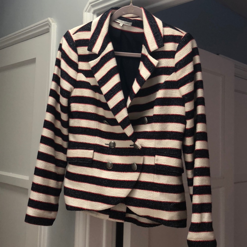 Cream and navy blazer with red stitching.